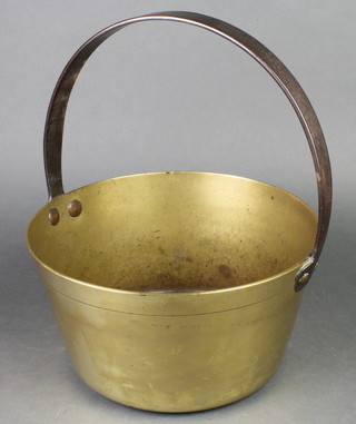 A brass preserving pan with iron handles 