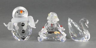 A Swarovski figure of a snowman 2", a ditto of a seated child 1 1/2" and a ditto swan 1" 