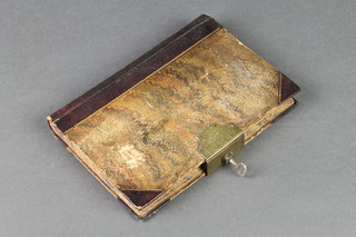 A Victorian leather half bound ledger complete with key 7" x 5" 