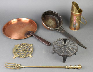 A circular copper saucepan lid with iron handle 9 1/2", a copper and brass spill holder 8", an iron footman, a brass footman etc 