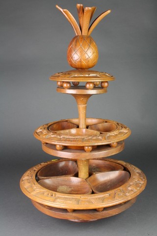 A circular carved hardwood 3 tier hors d'oeuvres stand with pineapple finial  26"h 