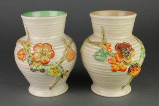 A pair of Clarice Cliff moulded polychrome baluster vases decorated with flowers 912 7" 
