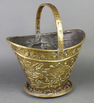 A boat shaped embossed brass coal bucket, old repairs to handle 