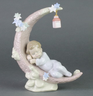 A Lladro figure of a child sleeping on the moon 7", no 6479