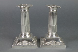 A pair of Victorian silver dwarf candlesticks with fluted columns and shell and scroll bases, Sheffield 1895, 5" 