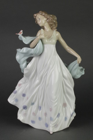 A Lladro figure of a lady with a bird sitting on her shawl 6193 12" 