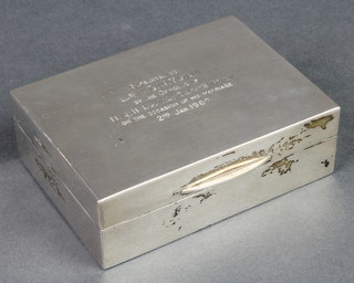 A rectangular silver cigarette box with presentation inscription, London 1958, 3 3/4" x 2 3/4"