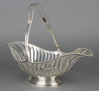 A pierced silver swing handled basket with beaded rim, Sheffield 1919, 580 grams