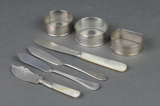 3 silver napkin rings and 4 ditto butter knives 