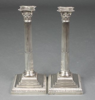 A pair of Edwardian silver Corinthian column candlesticks on stepped bases, London 1910, 12" 