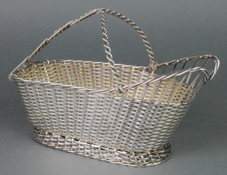 A silver plated Christofle bottle holder of basket design 