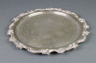 A Victorian silver salver with scroll border and chased floral decoration with vacant cartouche, London 1896, 566 grams 11" 
