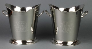 A pair of silver plated wine coolers with chased decoration 