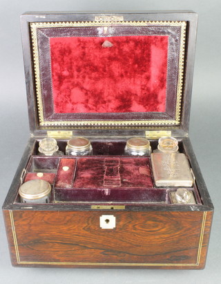 A Victorian rosewood brass mounted toilet box containing 5 silver plated mounted bottles