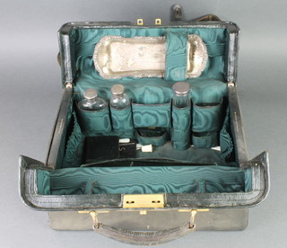 A leather travelling case containing 3 silver mounted bottles and minor items