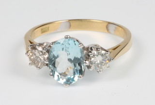 An 18ct yellow gold aquamarine 1 and 2 stone diamond ring, the centre stone approx. 1.5ct, the diamonds approx 0.5ct, size P 1/2