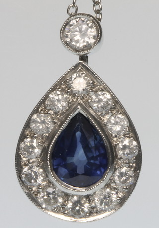 An 18ct white gold pear shaped sapphire and diamond pendant on chain 