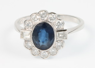 An 18ct white gold sapphire and diamond oval cluster ring, size P
