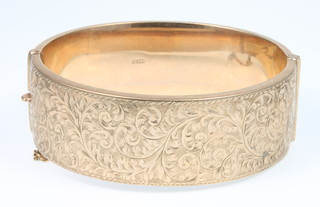 A 9ct gold engraved wide bangle, 32 grams