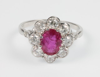 An 18ct white gold ruby and diamond oval cluster ring, the centre stone approx. 1.1ct surrounded by 8 brilliant cut diamond approx. 1.5ct, size O