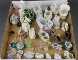 A collection of porcelain pottery and glass swans
