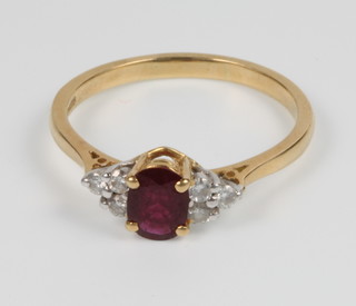 An 18ct yellow gold ruby and diamond ring, size R