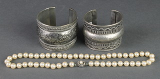 An imitation pearl necklace and 2 broad white metal bangles 