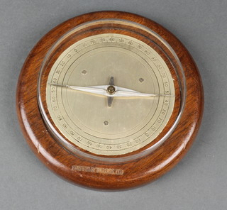 A circular turned oak and polished metal gauge/compass, calibrated 0-90 6" 