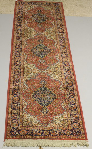 A pink ground Persian style Belgian cotton runner with stylised medallion  to the centre 114" x 29" 