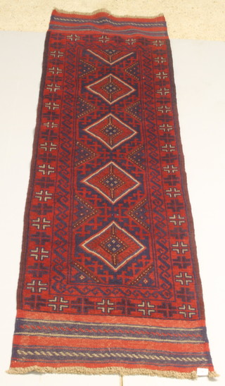 A Meshwani red ground runner with 4 stylised diamonds to the centre 98" x 27" 
