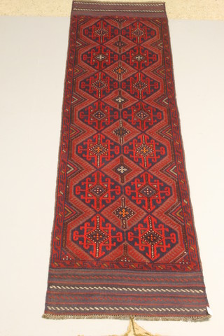 A red and blue Meshwani runner with stylised diamonds to the centre 103" x 25" 