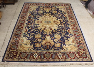 A Persian style blue and gold ground carpet with floral pattern and central medallion 135" x 100" 