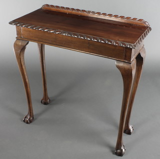 A Chippendale style rectangular mahogany side table with raised back and gadrooned decoration, raised on cabriole, claw and ball supports 31 1/2"h x 30"w x 13"d 