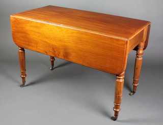 A 19th Century mahogany drop flap dining table fitted a frieze drawer and raised on turned supports ending in brass cappings 27"h x 42"w x 21" when closed by 41" when open