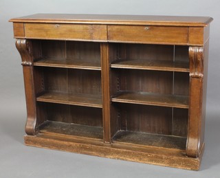 A Victorian oak open bookcase, the top fitted 2 secret drawers, the interior fitted adjustable shelves and having vitruvian scrolls to the sides, raised on a platform base 42"h x 58"w x 15 1/2"d 