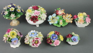 A collection of 8 porcelain and ceramic floral displays 
