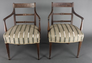 A pair of Georgian mahogany bar back carver chairs with upholstered seats, raised on square  supports, spade feet 