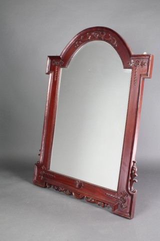 A Victorian style arched bevelled plate mirror contained in a carved mahogany frame 55" x 40" 