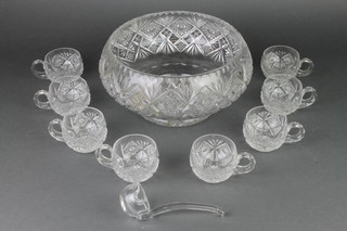 A cut glass punch bowl, 8 ditto cups and a ladle 