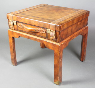 An occasional table in the form of a leather covered suitcase, fitted a drawer and raised on square tapering supports 23"h x 24"w x 22"d 