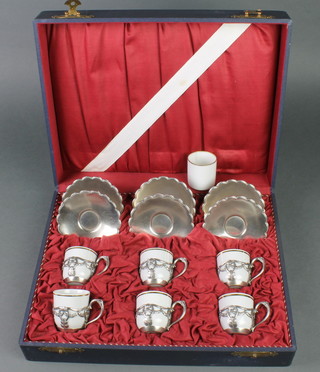 A German 6 piece cased coffee set with WMF holders and saucers together with a spare cup 
