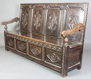 A Victorian carved oak settle of panelled construction with raised back 45"h x 73"w x 21"d 