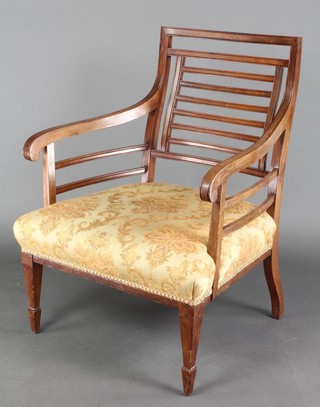 An Edwardian Art Nouveau mahogany ladder back armchair with upholstered seat, raised on square tapering supports 
