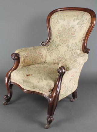 A Victorian mahogany show frame armchair upholstered in tapestry material on cabriole supports 