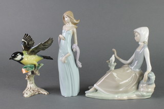 A Lladro figure of a seated lady looking at a dove 8", a ditto of a lady with scarf 8" and a Goebel figure of a great titmouse 6" 