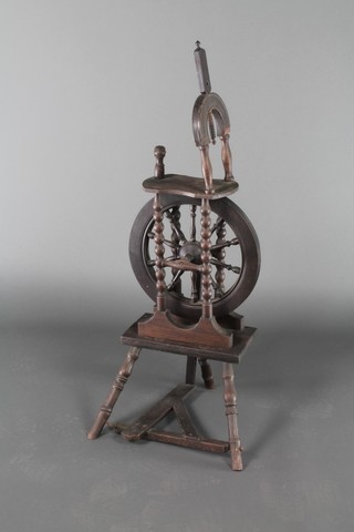 An oak spinning wheel 40"h x 14"w x 15"d 