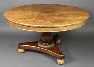 A circular Regency rosewood snap top breakfast table raised on urn turned column with triform base, bun feet 27"h x 51" diam