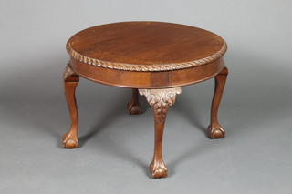 A circular mahogany Chippendale style occasional table with gadrooned border raised on cabriole ball and claw supports 17"h x 23" diam. 