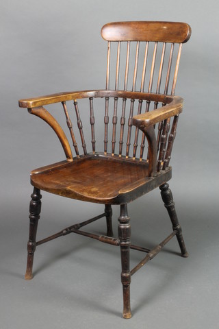 A 19th Century mahogany stick and rail back carver chair with solid seat