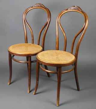 A pair of Art Nouveau Thonet bentwood chairs with woven cane seats, each labelled and stamped Thonet, 1 with a cracked rail to base 